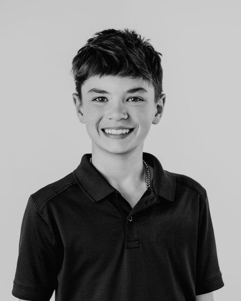 black and white school portrait of a boy in a navy polo, Denver Colorado
