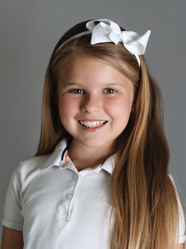 school portrait of a girl in a white polo on picture day in Denver