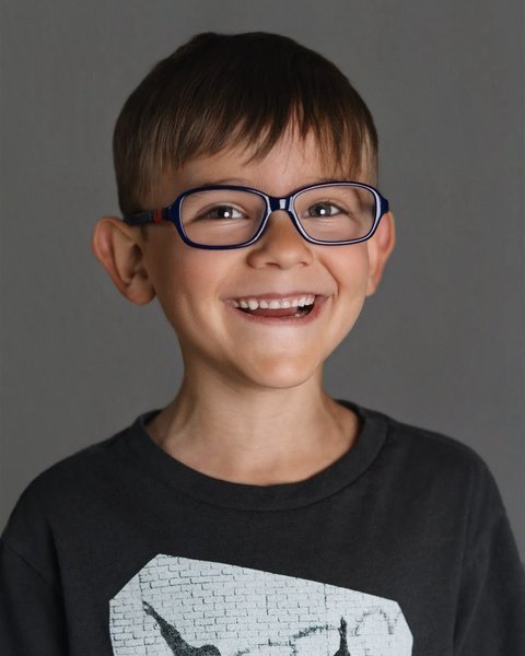 school portrait of a boy in glasses and a graphic tee, Denver Colorado