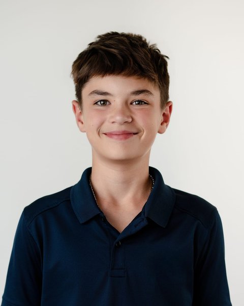 school picture day portrait of a boy in a navy polo, Denver Colorado