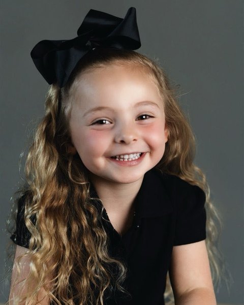 school portrait of a girl with a black bow, Denver Colorado